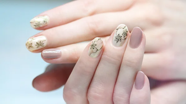 depositphotos_112162690-Nail-design-Manicure-nail-paint-beautiful-female-hand-with-colorful-nail-art-design-manicure